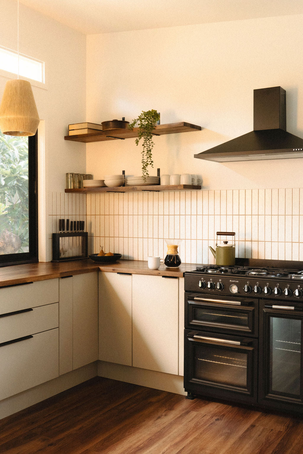 Bright modern kitchen with clean wooden counters, black oven, and natural light styled for a safe, eco-friendly home.